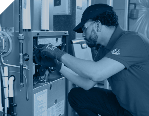 an Isaac heating and air conditioning technician works on a customer HVAC system