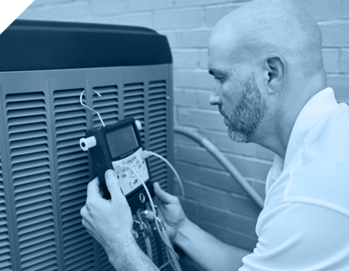 an HVAC tech tests an outdoor AC unit while working for Santa Fe heating and air